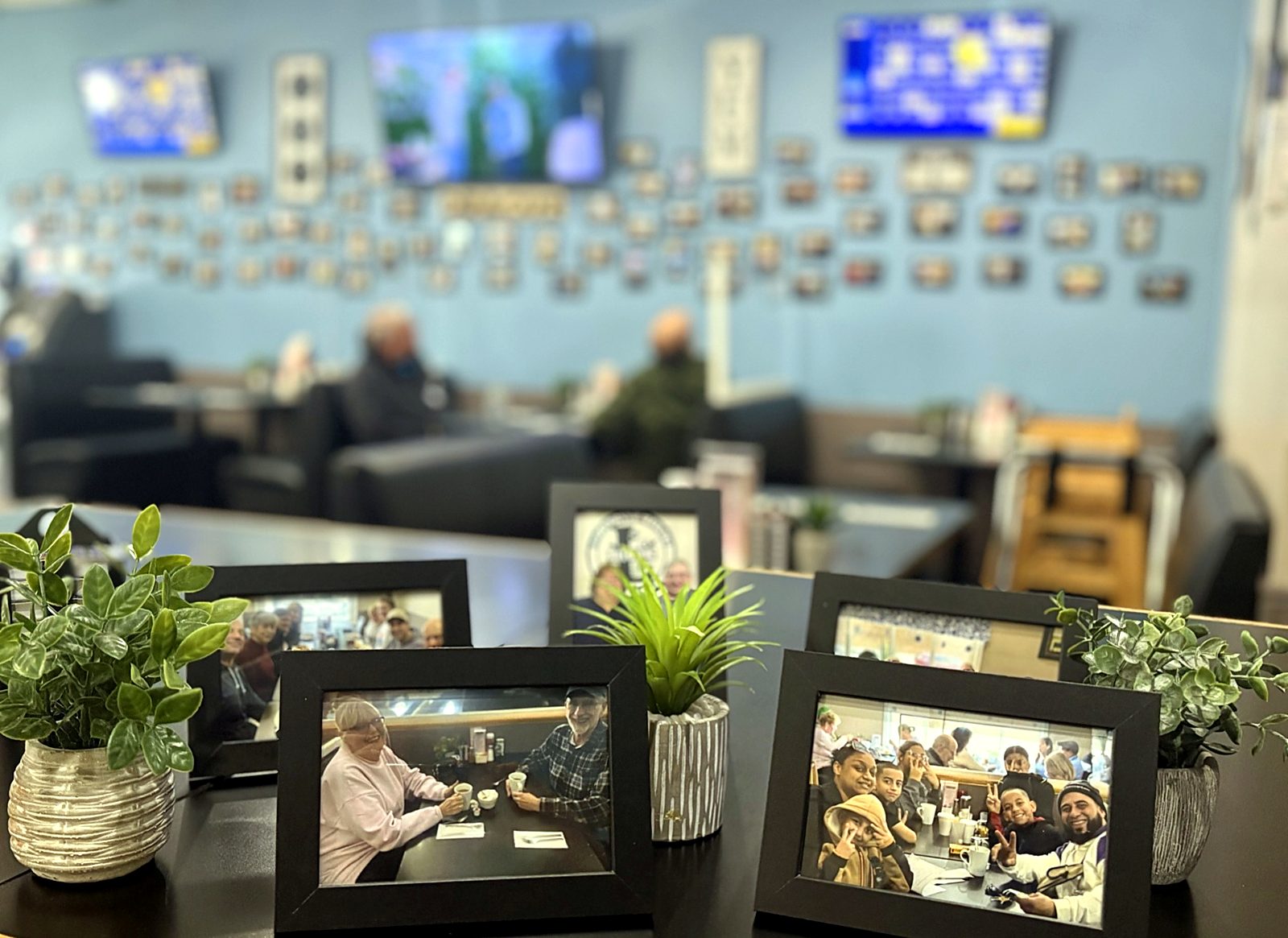The photo wall of regulars